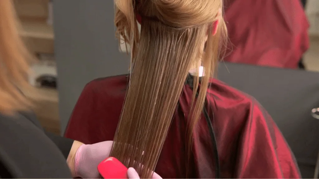 Hair stylist brushing a woman's hair